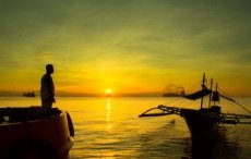 Photo of a boat at sunrise in the Philippines